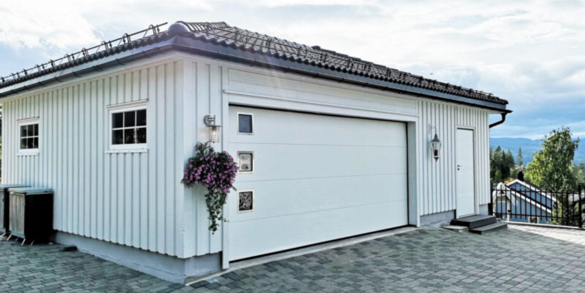 Garasje fra Igland Garasjen i sommerlige omgivelser.